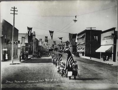 Street Parade at Chewelah Fair Oct. 2, 1913 On the left side of the street is the Chewelah Hotel 